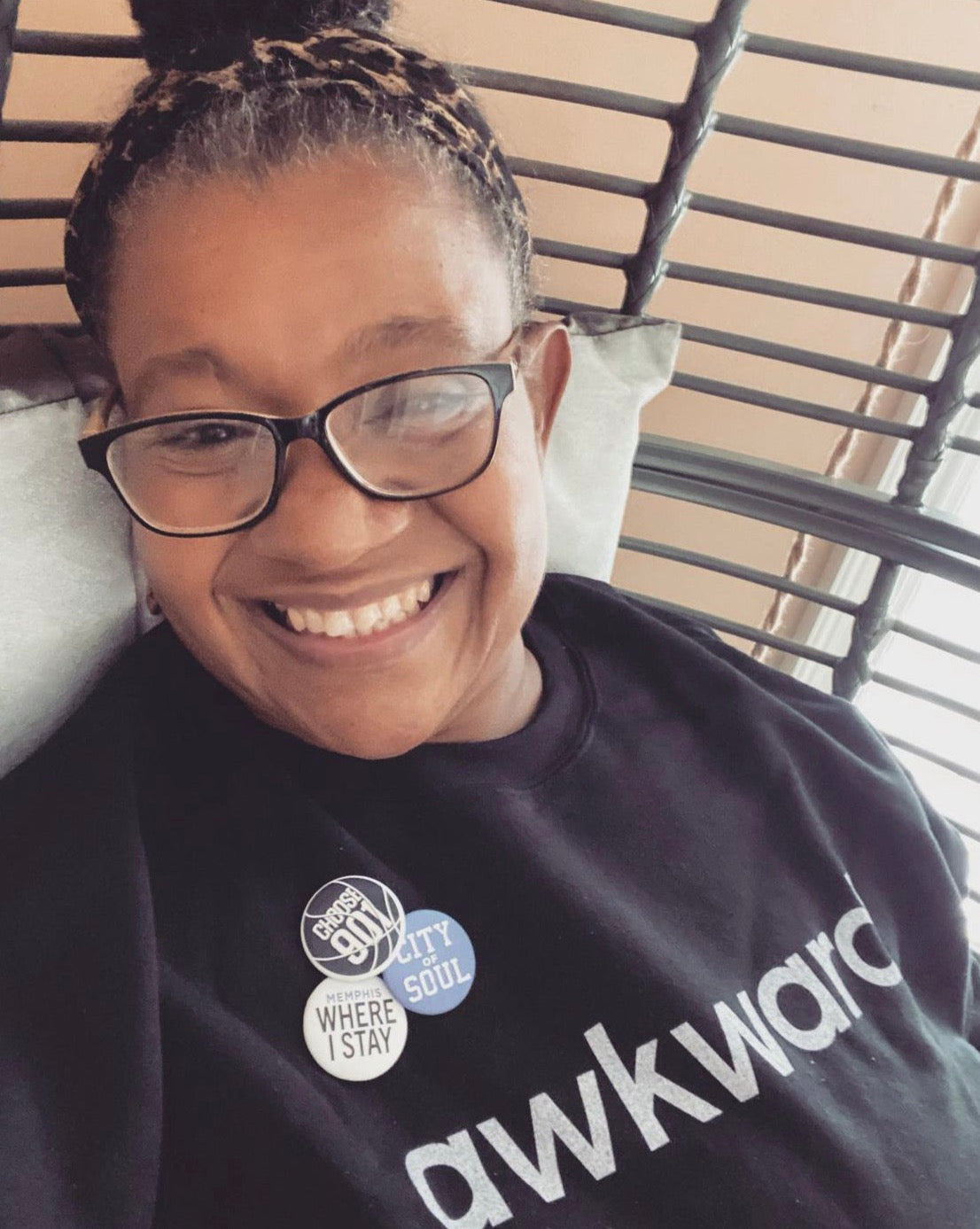 Woman wears black crewneck sweatshirt with white awkward text 